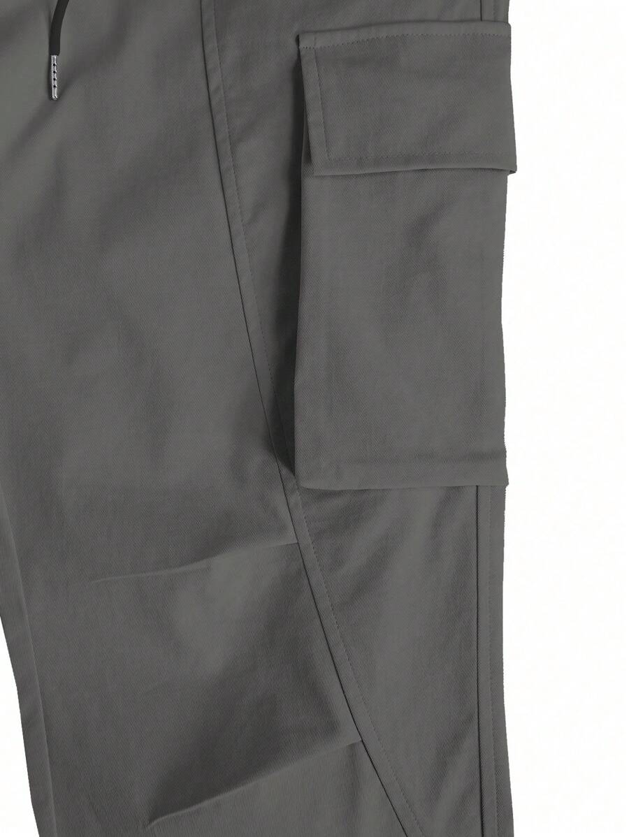 Muške široke cargo pantalone jednobojne sa pertlom u struku i džepovima
