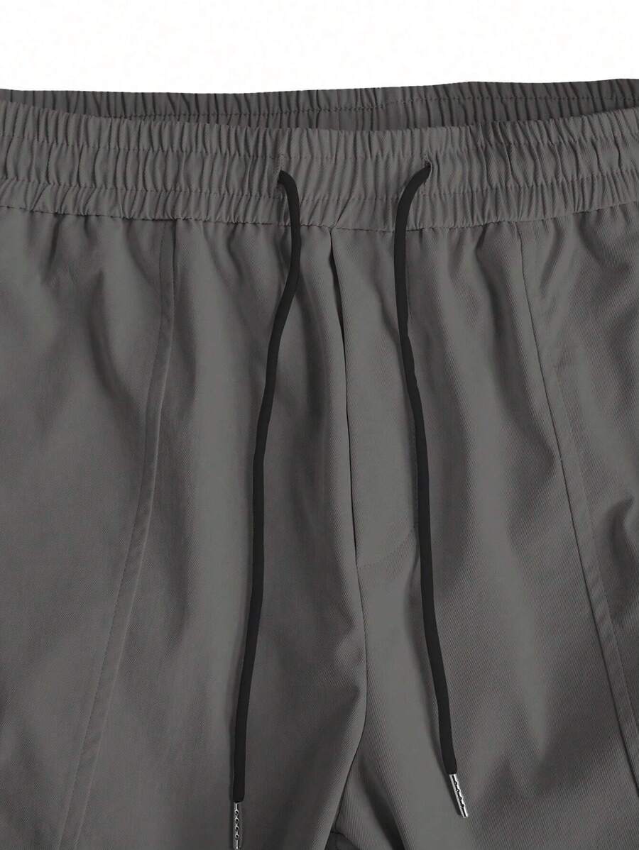 Muške široke cargo pantalone jednobojne sa pertlom u struku i džepovima