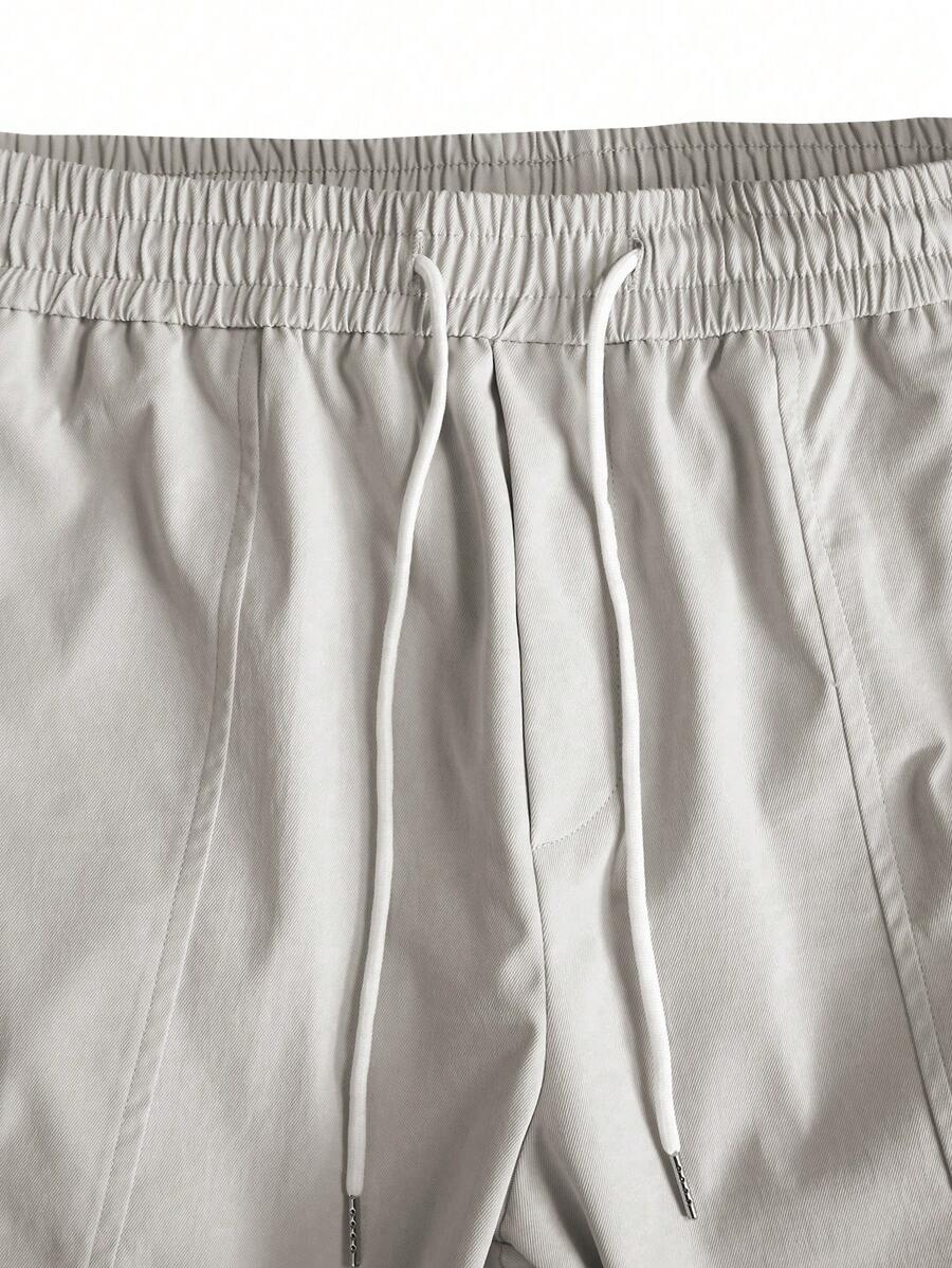 Muške široke cargo pantalone jednobojne sa pertlom u struku i džepovima