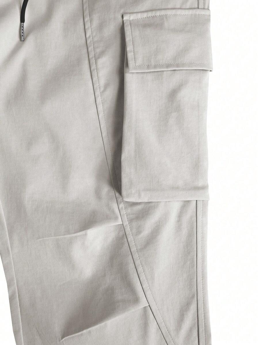 Muške široke cargo pantalone jednobojne sa pertlom u struku i džepovima